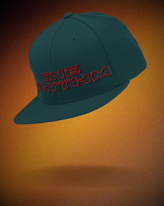 Spruce snapback hat with red embroidered “ONE RHYTHM” lettering. Minimal streetwear cap for DJs and techno music fans.