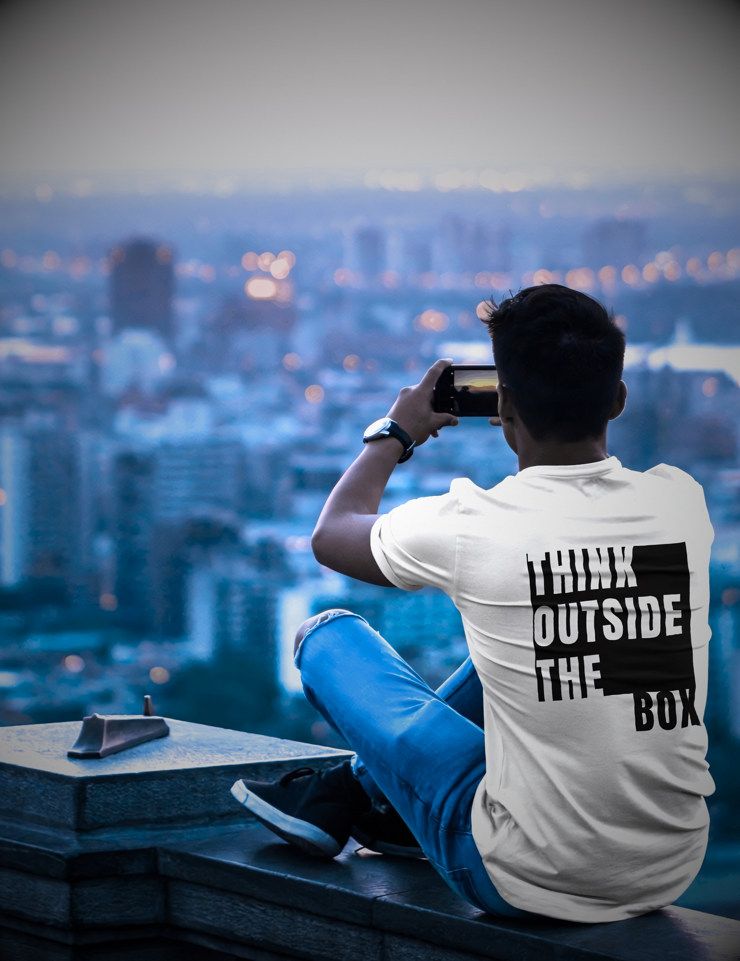 White T-shirt with the text ‘Think Outside the Box’ in bold white typography
