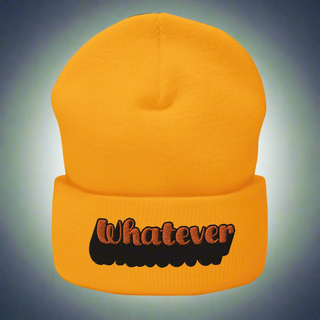 Gold beanie with 'Whatever' text embroidered in orange and black, trendy typography streetwear accessory.