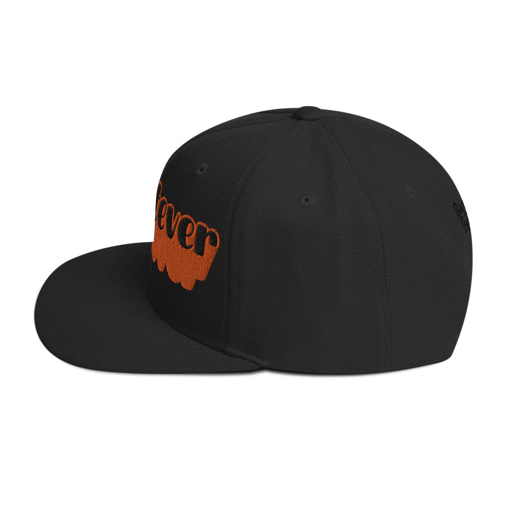 "Whatever" Snapback Hat in black with bold orange embroidered text, perfect for streetwear fashion.